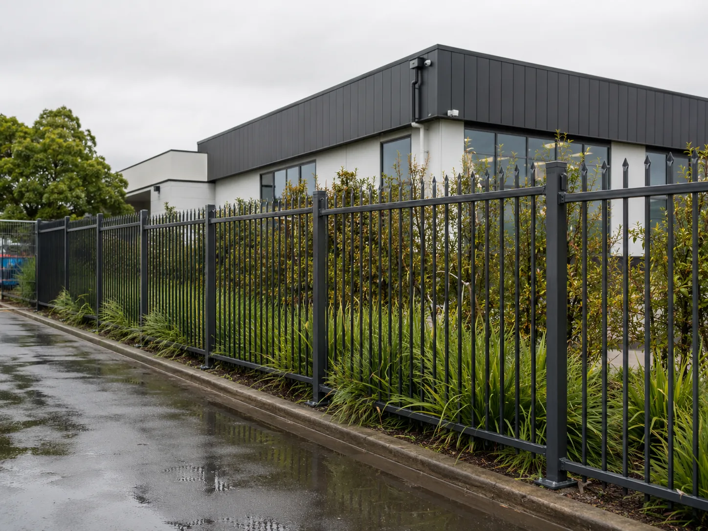 Black aluminium security fence outside a modern commercial building