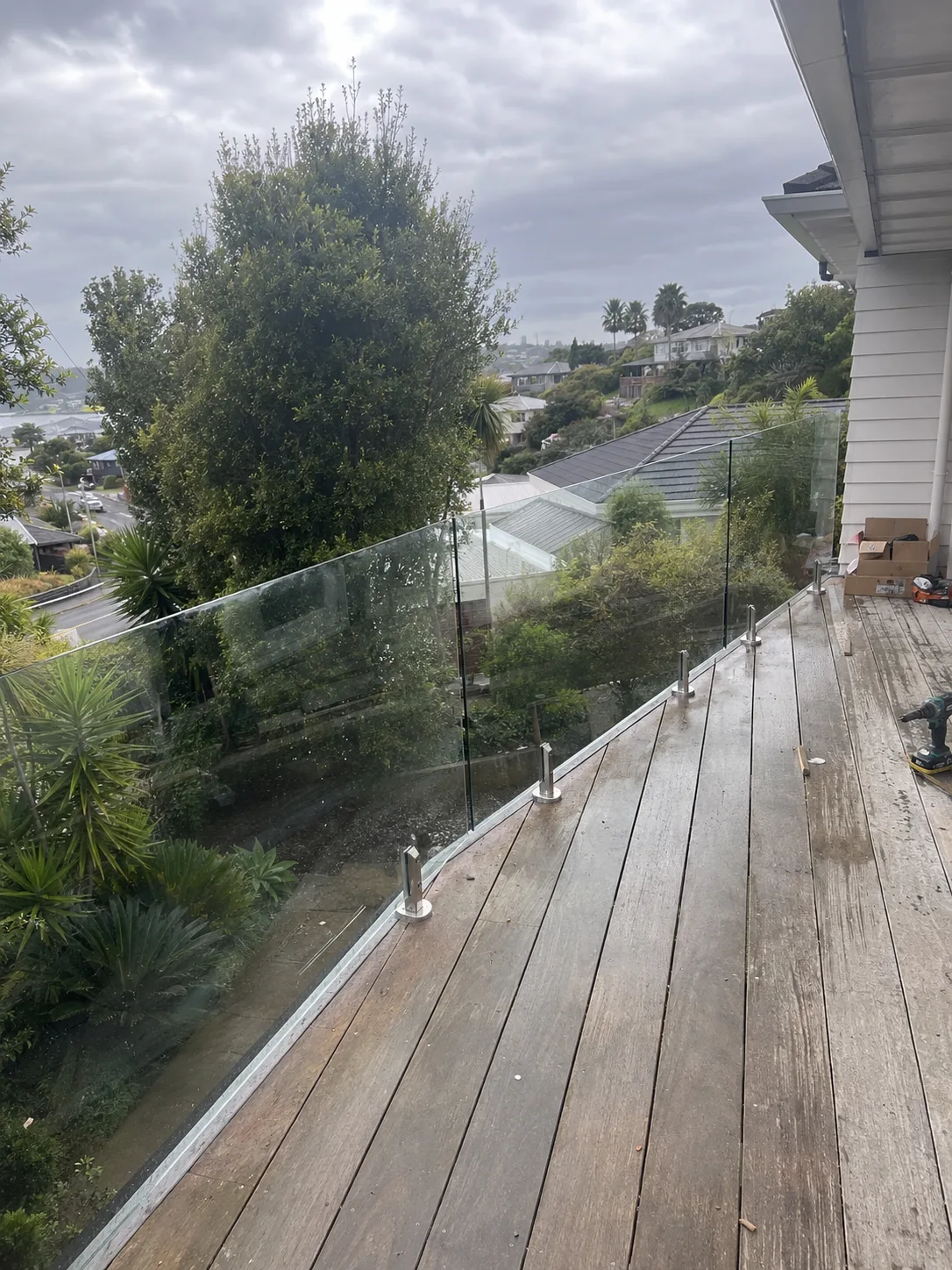 Frameless glass balustrade around an elevated timber deck