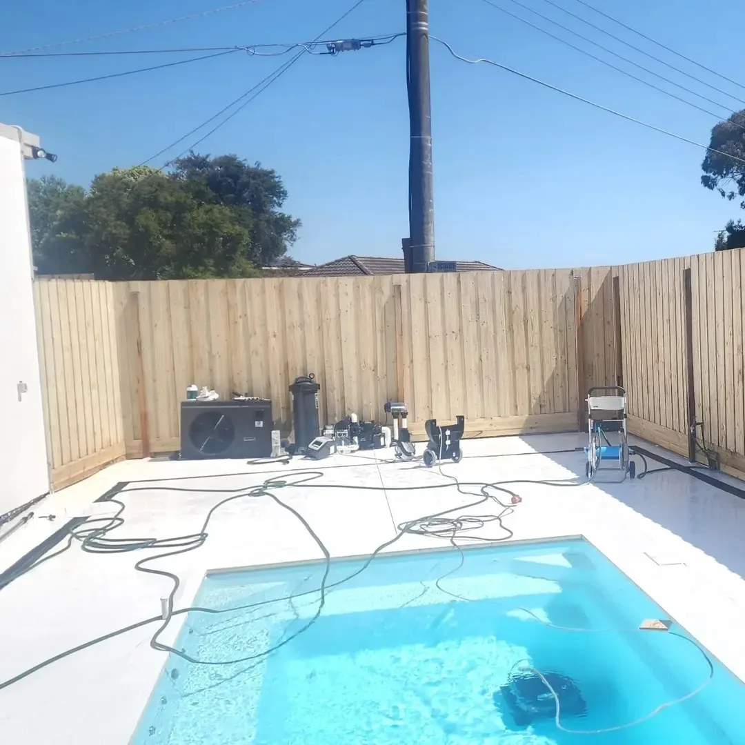 New timber paling fence beside a small pool during construction